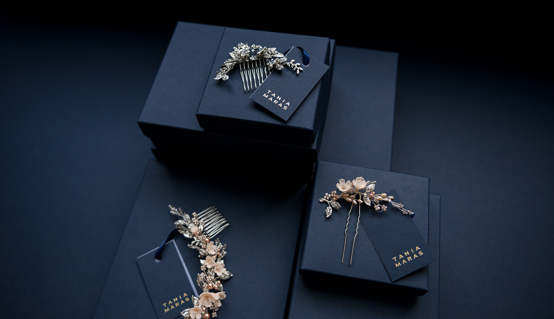 Bridal hair accessories with navy blue packaging and gold foils.