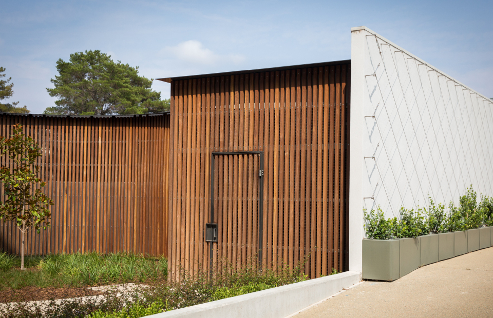 Photo of building with timber cladding and greenery
