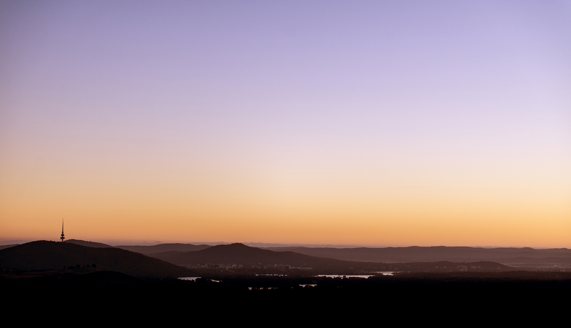 Panoramic photograph of the sunrise over Canberra and the Molonglo Valley.