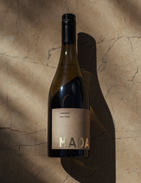 Mada wine bottle on a stone background.
