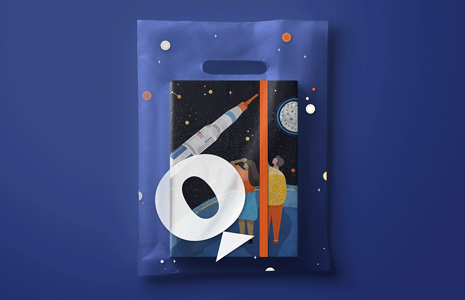 Notebook in transparent Questacon branded bag. Notebook features a stylised illustration of two people standing on earth looking and pointing to a rocket on its way to the moon which is in the far distance.