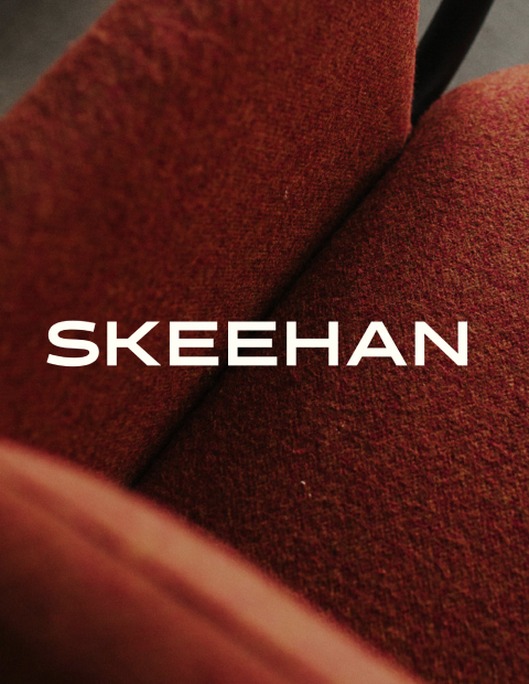 White SKEEHAN logo on photo of red chair