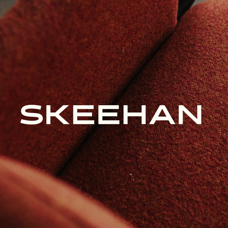 White SKEEHAN logo on photo of red chair