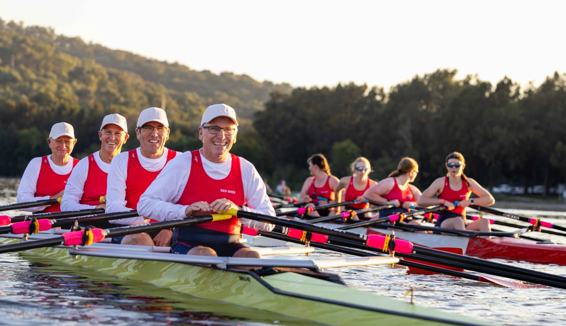 Two quad boats with rowers on water