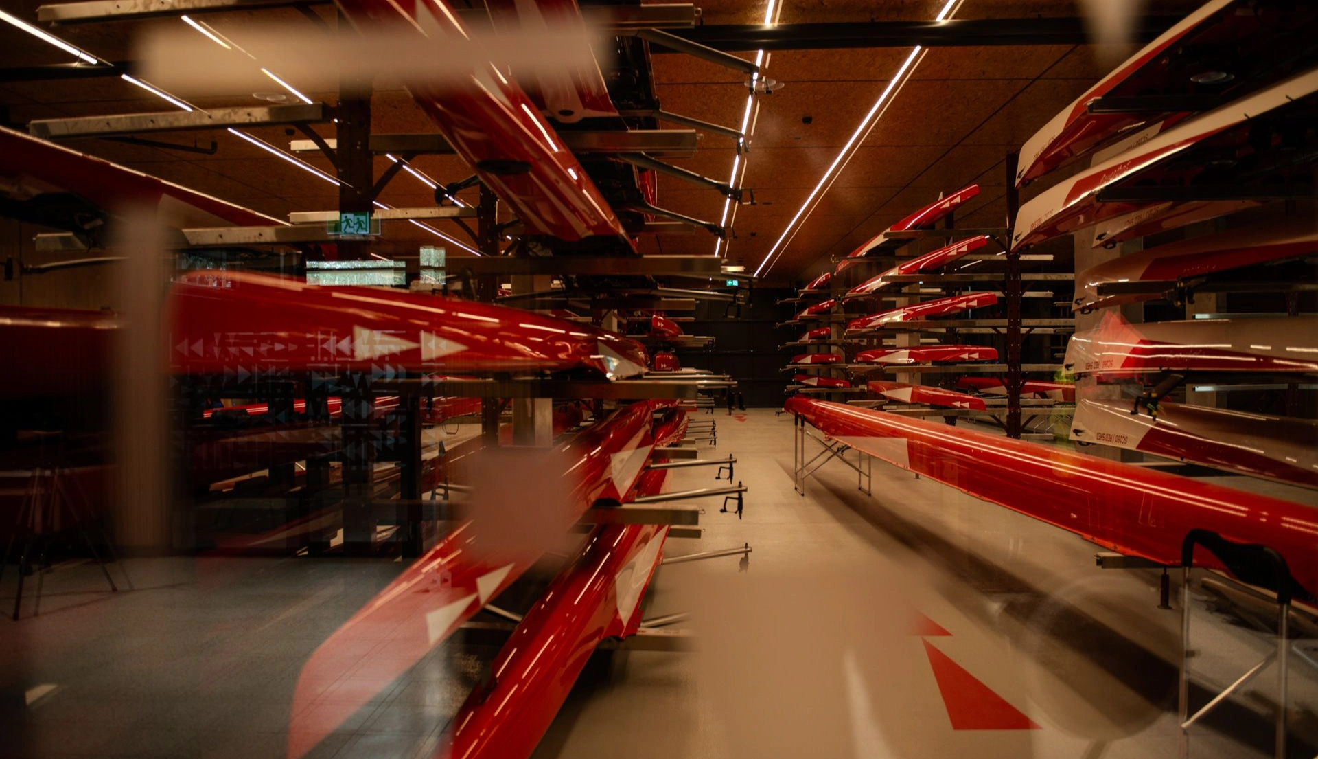 Inside Red Shed rowing storage, shot through window with transparent vinyl graphics
