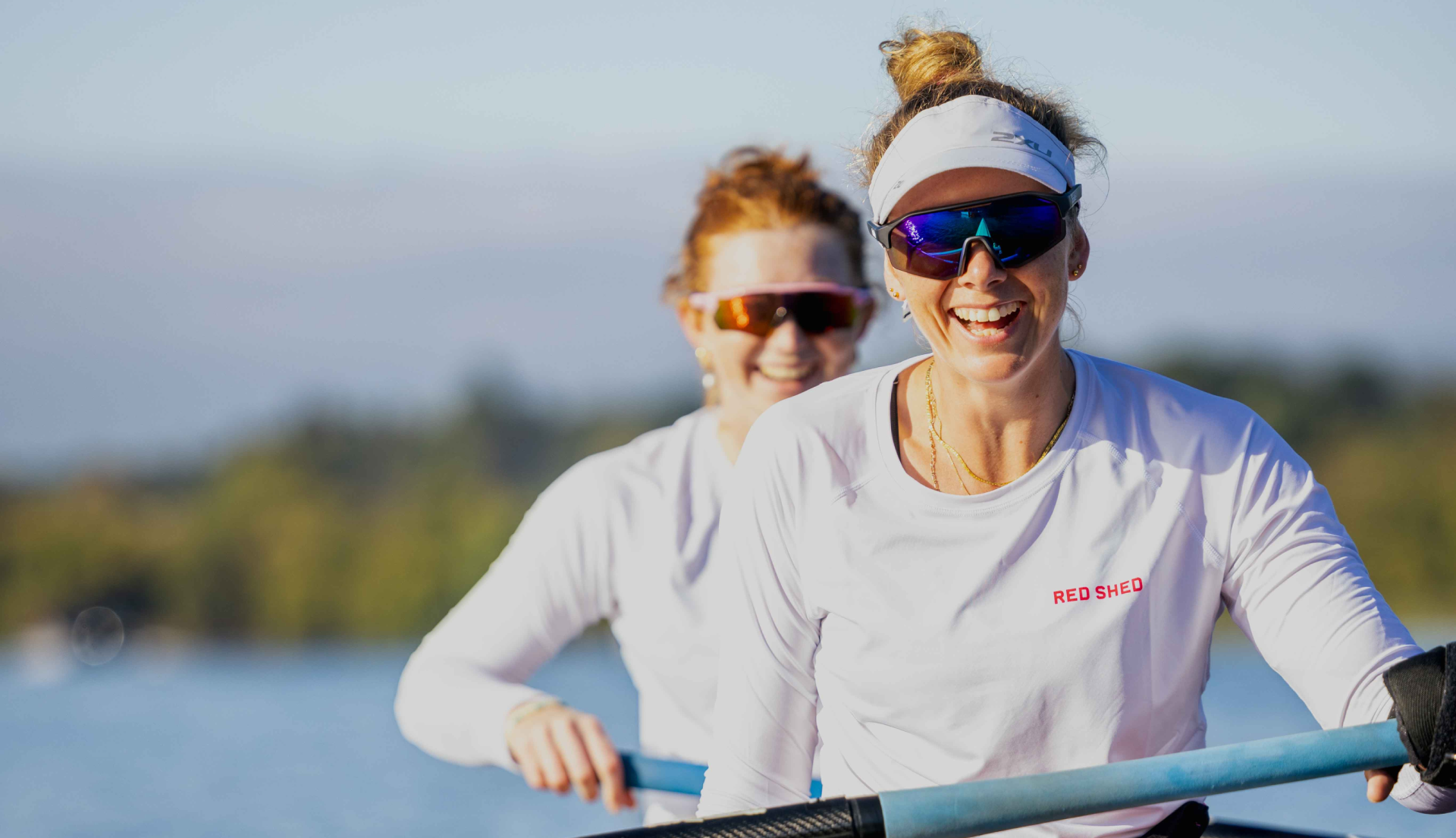 Red Shed rowers in row boat on Lake Burley Griffin, Canberra. Showing off the Red Shed branding.
